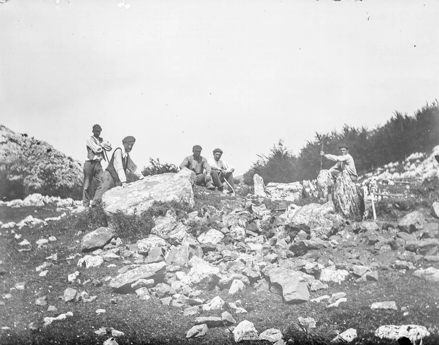 Hommes près du dolmen de Jentillarri, « pierre des jentils » attribuée aux géants, photographie de 1917.